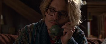 Movie still from “Secret Window” (2004), directed by David Koepp – A man talking on a phone while wearing glasses; Close Up shot, High angle