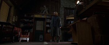 Movie still from “Secret Window” (2004), directed by David Koepp – A man standing in front of a bookcase in a living room; Wide shot, Low angle