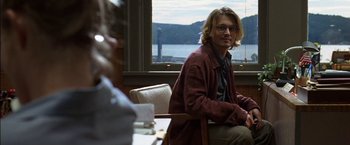 Movie still from “Secret Window” (2004), directed by David Koepp – A man sitting at a table in front of another man; Medium shot, Over the shoulder angle