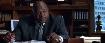 Movie still from “Secret Window” (2004), directed by David Koepp – A man sitting at a desk in a suit and tie; Close Up shot, Low angle
