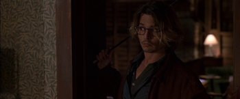 Movie still from “Secret Window” (2004), directed by David Koepp – A man holding a wooden stick in his hand; Close Up shot, Over the shoulder angle