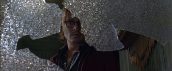 Movie still from “Secret Window” (2004), directed by David Koepp – A man with glasses is holding an umbrella; Close Up shot, Low angle
