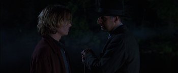 Movie still from “Secret Window” (2004), directed by David Koepp – A man in a hat and a man in a suit and tie; Medium shot, Over the shoulder angle