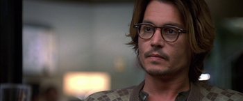 Movie still from “Secret Window” (2004), directed by David Koepp – A man with long brown hair wearing glasses; Close Up shot, Over the shoulder angle