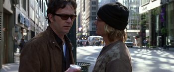 Movie still from “Secret Window” (2004), directed by David Koepp – Two men are standing on the sidewalk talking; Close Up shot, Over the shoulder angle