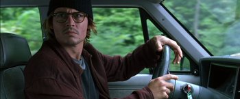 Movie still from “Secret Window” (2004), directed by David Koepp – A man driving a car in a forest; Close Up shot, High angle