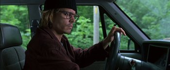 Movie still from “Secret Window” (2004), directed by David Koepp – A man driving a car in a forest; Close Up shot, Low angle