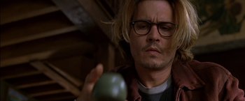 Movie still from “Secret Window” (2004), directed by David Koepp – A man holding an apple in front of his face; Close Up shot, High angle