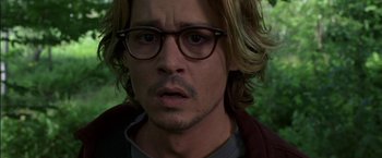Movie still from “Secret Window” (2004), directed by David Koepp – A man with long blonde hair wearing glasses; Close Up shot, High angle