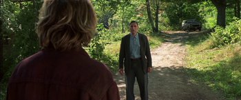 Movie still from “Secret Window” (2004), directed by David Koepp – A man and a woman are standing in the woods; Medium shot, Over the shoulder angle