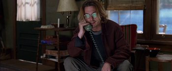 Movie still from “Secret Window” (2004), directed by David Koepp – A man talking on a phone while sitting on the floor; Medium shot, Low angle