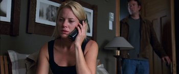 Movie still from “Secret Window” (2004), directed by David Koepp – A woman talking on a cell phone in a room; Medium shot, Over the shoulder angle