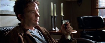 Movie still from “Secret Window” (2004), directed by David Koepp – A person holding a glass of wine; Close Up shot, High angle