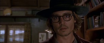 Movie still from “Secret Window” (2004), directed by David Koepp – A man with a black hat and glasses on; Close Up shot, Over the shoulder angle