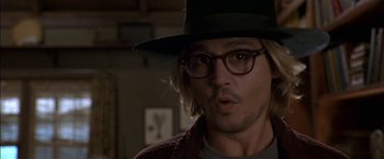 Movie still from “Secret Window” (2004), directed by David Koepp – Johnny depp in a hat and glasses in a room; Close Up shot, Over the shoulder angle