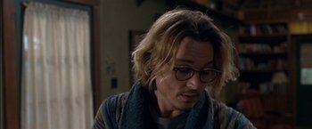 Movie still from “Secret Window” (2004), directed by David Koepp – A man with long blonde hair wearing glasses; Close Up shot, Over the shoulder angle