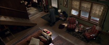 Movie still from “Secret Window” (2004), directed by David Koepp – A man kneeling in front of a television in a living room; Wide shot, Overhead angle