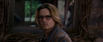 Movie still from “Secret Window” (2004), directed by David Koepp – A man with long blonde hair wearing round glasses; Close Up shot, Over the shoulder angle