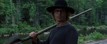 Movie still from “Secret Window” (2004), directed by David Koepp – A man in a hat holding onto a stick; Close Up shot, Over the shoulder angle