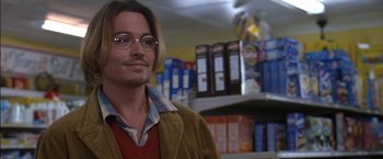 Movie still from “Secret Window” (2004), directed by David Koepp – A man with glasses is standing in front of a shelf; Close Up shot, Over the shoulder angle
