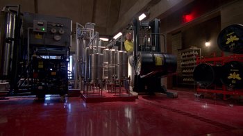 Movie still from “Breaking Bad” (2008), created by Vince Gilligan – A man standing in front of a machine in a room; Extreme Wide shot, High angle
