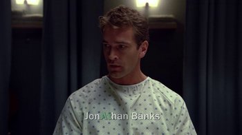 Movie still from “Breaking Bad” (2008), created by Vince Gilligan – A man wearing a hospital gown in the dark; Close Up shot, Overhead angle