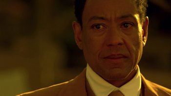 Movie still from “Breaking Bad” (2008), created by Vince Gilligan – A person wearing a suit and tie; Close Up shot, Low angle