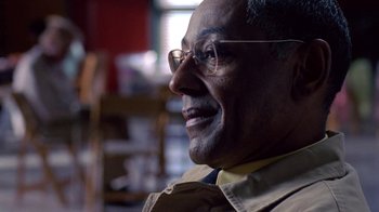 Movie still from “Breaking Bad” (2008), created by Vince Gilligan – An older man wearing glasses looking to his left; Close Up shot, Low angle