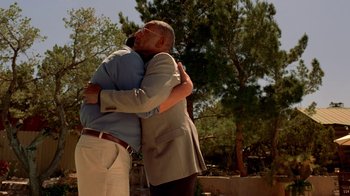 Movie still from “Breaking Bad” (2008), created by Vince Gilligan – A couple of people that are hugging each other; Medium shot, Low angle