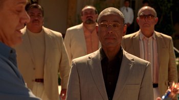 Movie still from “Breaking Bad” (2008), created by Vince Gilligan – A group of men standing next to each other in suits; Medium shot, Low angle