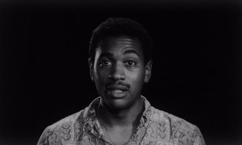 Movie still from “She's Gotta Have It” (1986), directed by Spike Lee – A black and white photo of a man with a mustache; Close Up shot, Low angle