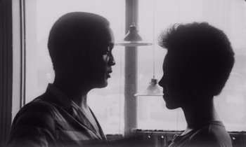 Movie still from “She's Gotta Have It” (1986), directed by Spike Lee – Two women face each other in front of a window; Close Up shot, Low angle