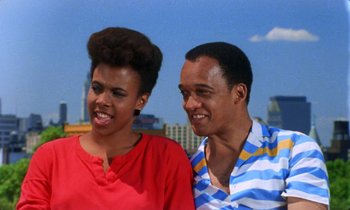 Movie still from “She's Gotta Have It” (1986), directed by Spike Lee – A man and a woman standing next to each other; Medium shot, Low angle