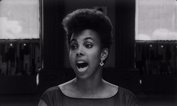 Movie still from “She's Gotta Have It” (1986), directed by Spike Lee – A black and white photo of a woman with an open mouth; Close Up shot, Low angle