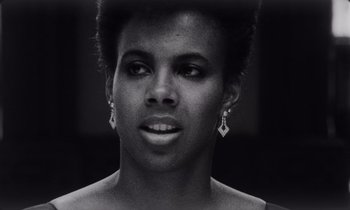 Movie still from “She's Gotta Have It” (1986), directed by Spike Lee – A black and white photo of a woman's face; Close Up shot, Low angle
