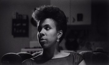 Movie still from “She's Gotta Have It” (1986), directed by Spike Lee – A black and white photo of a woman looking up; Close Up shot, Low angle