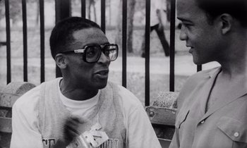 Movie still from “She's Gotta Have It” (1986), directed by Spike Lee – A black - and - white photo of two people talking; Close Up shot, Low angle