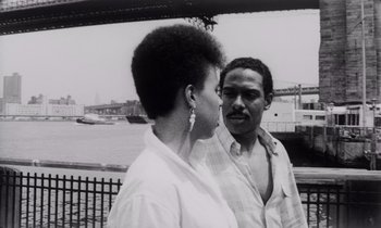 Movie still from “She's Gotta Have It” (1986), directed by Spike Lee – A black and white photo of a man and a woman; Close Up shot, Low angle