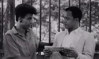 Movie still from “She's Gotta Have It” (1986), directed by Spike Lee – A man and a woman looking at each other while standing next to each other; Medium shot, Low angle