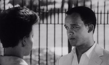 Movie still from “She's Gotta Have It” (1986), directed by Spike Lee – A black and white photo of a man and a woman; Close Up shot, Over the shoulder angle