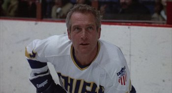 Movie still from “Slap Shot” (1977), directed by George Roy Hill – A hockey player on the ice; Medium shot, Low angle