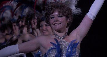 Movie still from “Slap Shot” (1977), directed by George Roy Hill – A woman in a blue and white dress and a woman in a blue and white dress; Close Up shot, Low angle