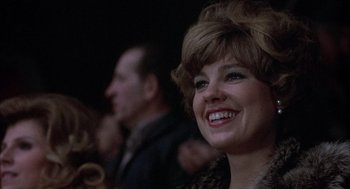 Movie still from “Slap Shot” (1977), directed by George Roy Hill – A person with a smile on their face; Close Up shot, Low angle
