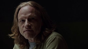 Movie still from “Slasher” (2016), created by Aaron Martin – A person with long hair; Close Up shot, Over the shoulder angle