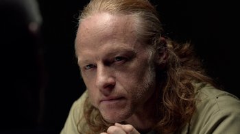 Movie still from “Slasher” (2016), created by Aaron Martin – A person with long blonde hair; Close Up shot, Low angle