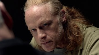 Movie still from “Slasher” (2016), created by Aaron Martin – A person with long blonde hair; Close Up shot, Over the shoulder angle