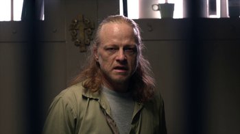 Movie still from “Slasher” (2016), created by Aaron Martin – A person with long hair; Close Up shot, Over the shoulder angle