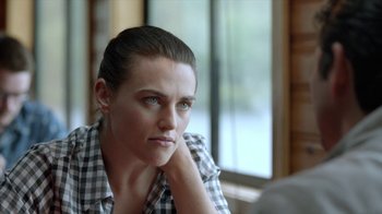 Movie still from “Slasher” (2016), created by Aaron Martin – A person sitting in a room; Close Up shot, Over the shoulder angle