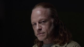 Movie still from “Slasher” (2016), created by Aaron Martin – A person with long red hair; Close Up shot, Over the shoulder angle