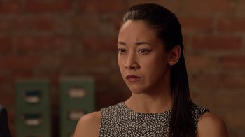 Movie still from “Slasher” (2016), created by Aaron Martin – A person wearing a black and white dress; Close Up shot, Over the shoulder angle